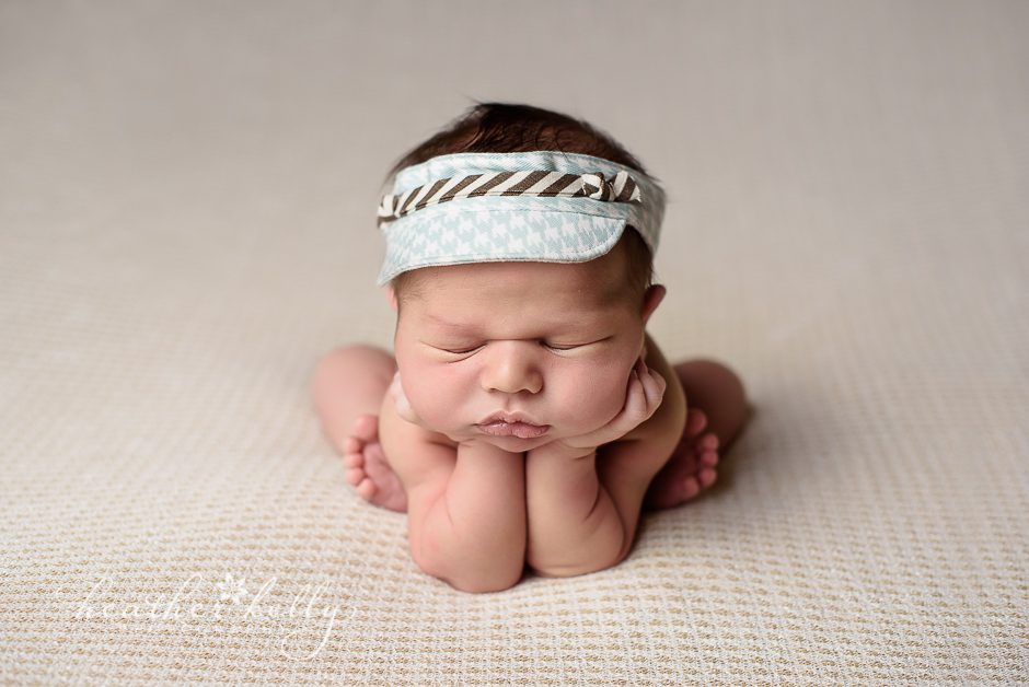baby boy in froggie pose with visor