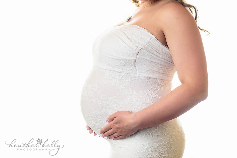 backlit studio maternity image of pregnant belly