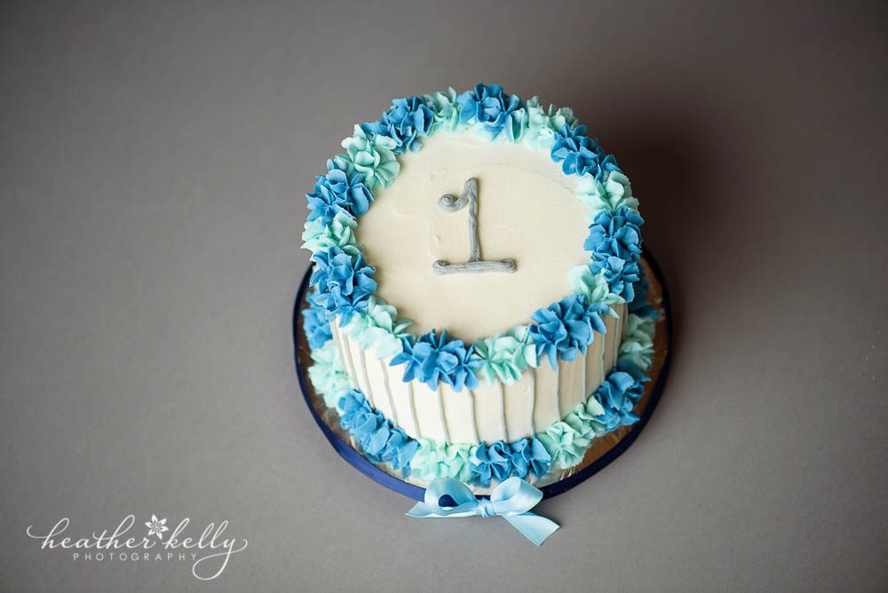 white, blue and gray first birthday cake