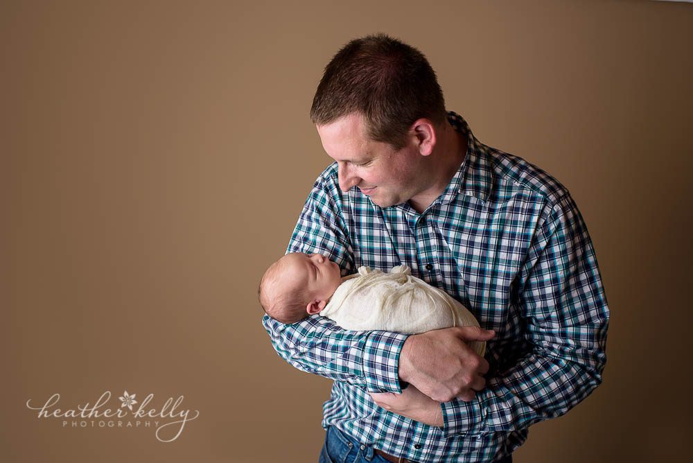 dad holding newborn boy