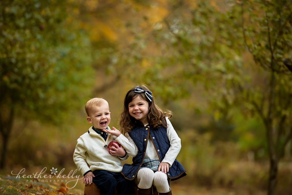 brookfield family photos of brother and sister laughing on crate in October