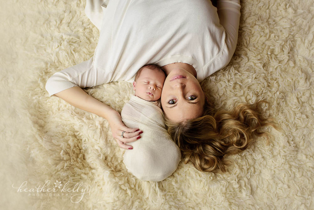 gorgeous mom and newborn laying down on rug photo trumbull ct