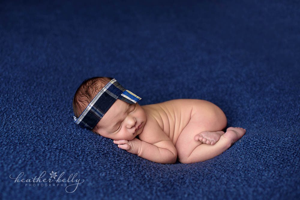 adorable newborn photo of 8 day boy with visor fairfield newborn ct photographer