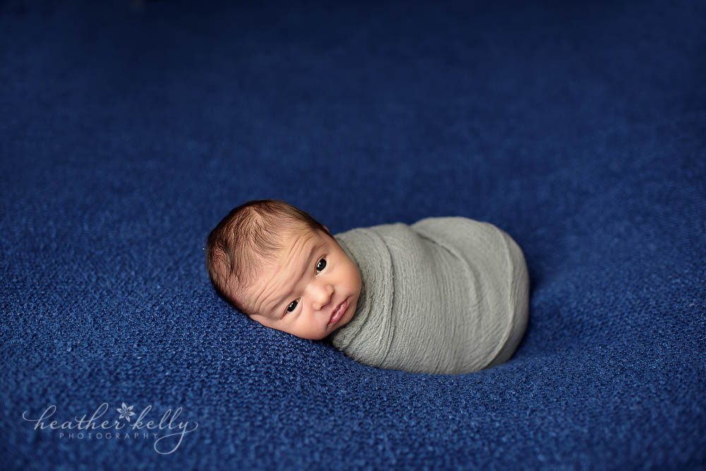 awake newborn boy in gray wrap photo fairfield newborn ct photographer