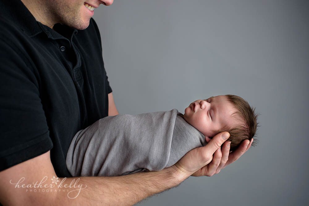 baby in dads hands newborn photography shelton ct newborn photos