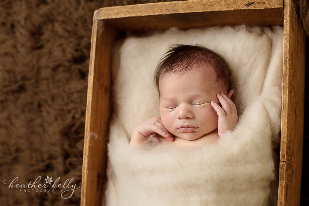 favorite prop pose photo of little boy tucked in crate newborn blog circle