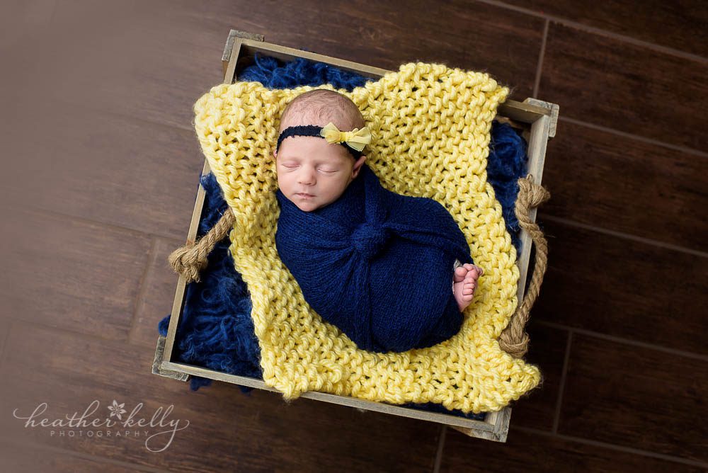 baby girl in square crate. navy and yellow. newtown ct twins