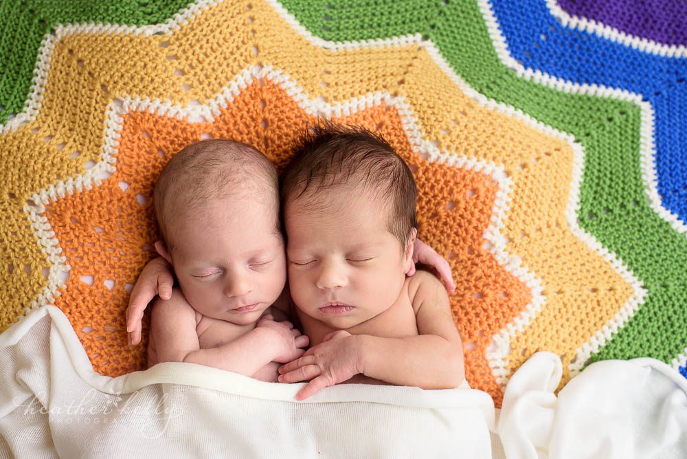newborn twin girls on rainbow blanket. newtown ct twins.