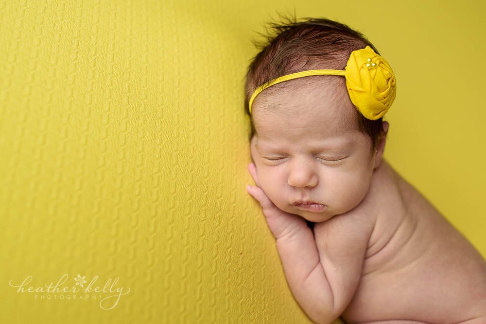 newborn posing of baby girl on yellow blanket. newtown ct twins. 