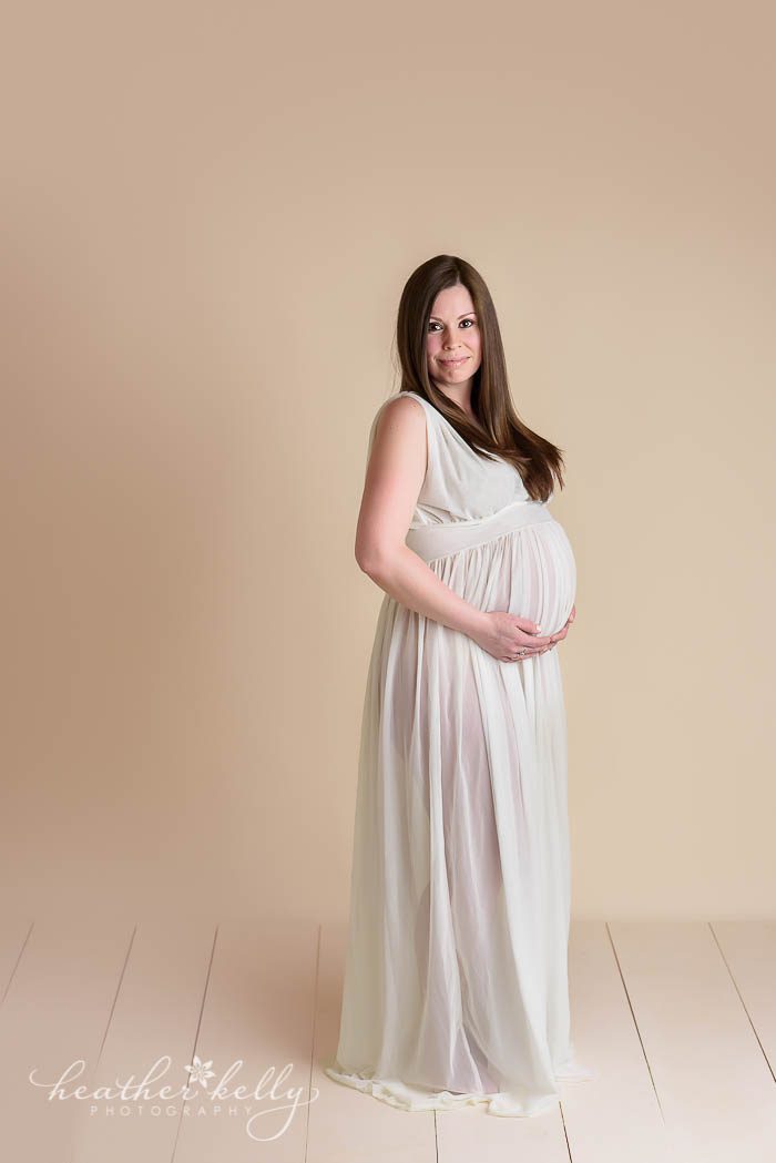 maternity photography of mom wearing long white gown. Full body maternity photo. CT photographer Heather Kelly Photography