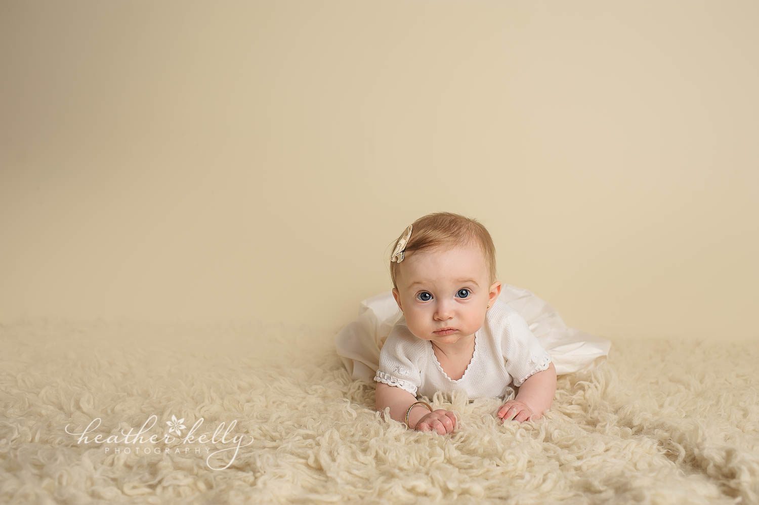 7 month girl laying on rug during baptism portrait photography. Bethel ct baby photographer heather kelly photography