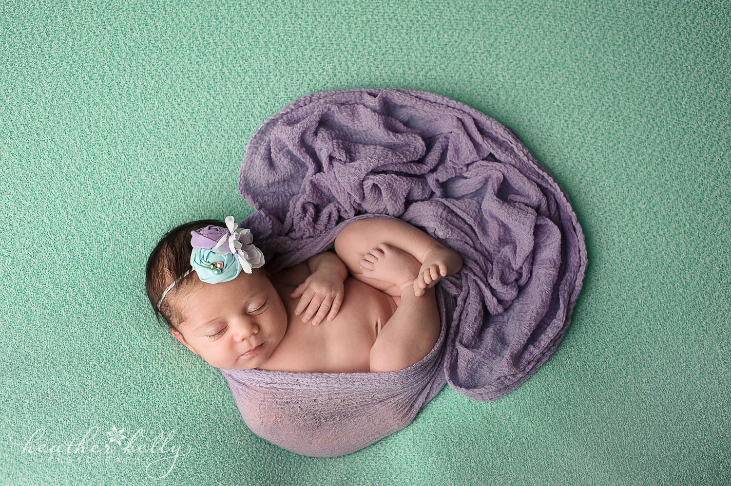 newborn photography photo. Baby girl on mint with purple wrap. Shot from above. Weston ct newborn photography