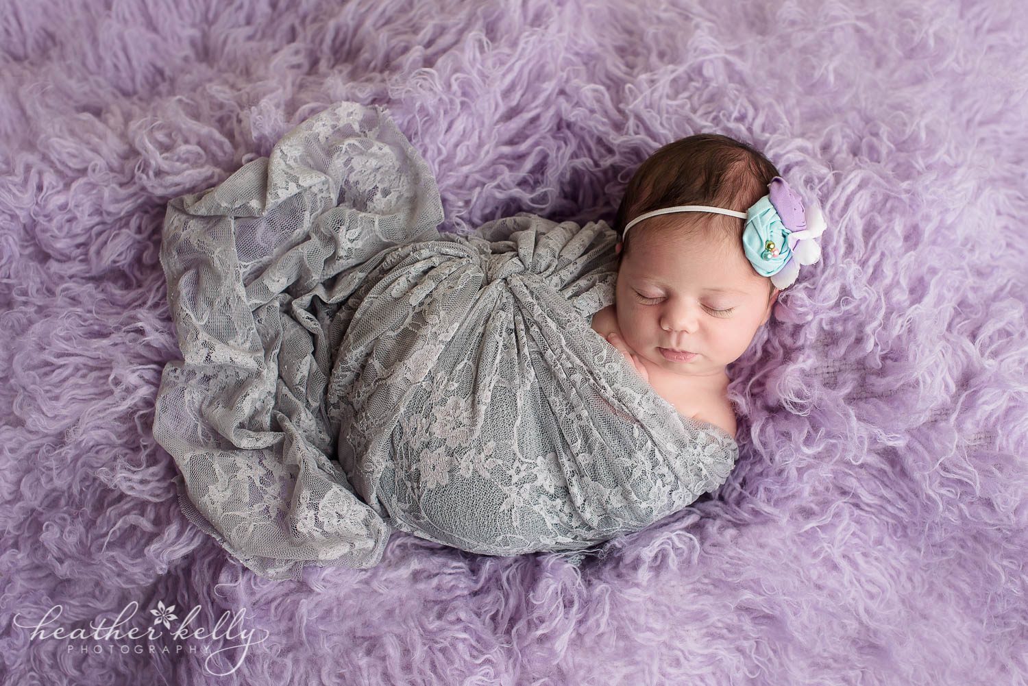 newborn girl wrapped in gray wrap on lavender flokati. lavender, gray, mint newborn session. Weston ct newborn photography