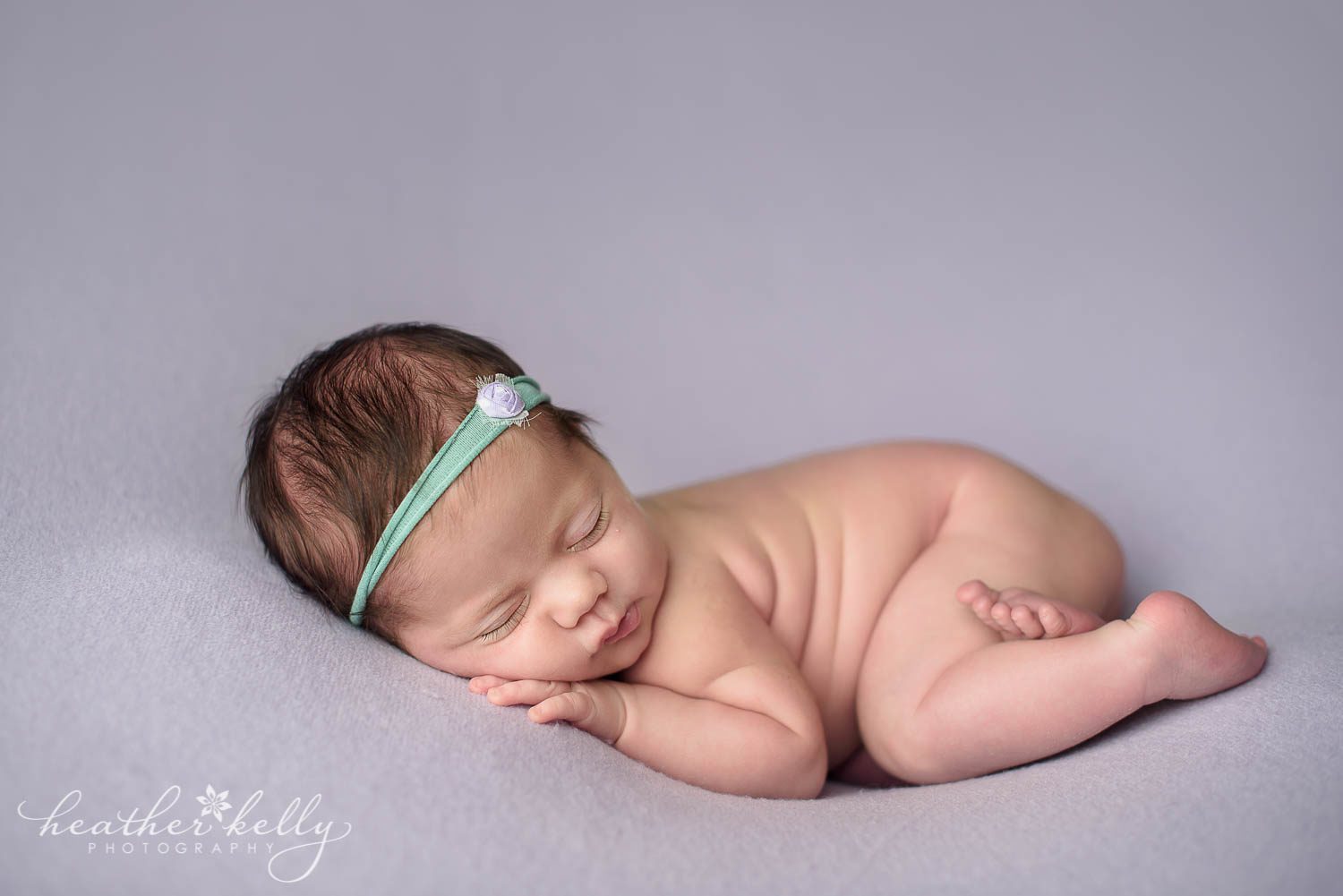 mint and lavender newborn photo of baby girl on belly. Weston ct newborn photography