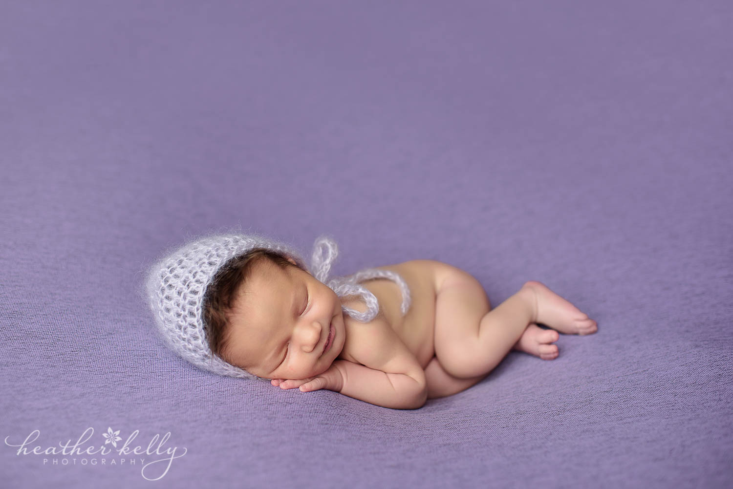 baby girl lavender bonnet newborn photography poses