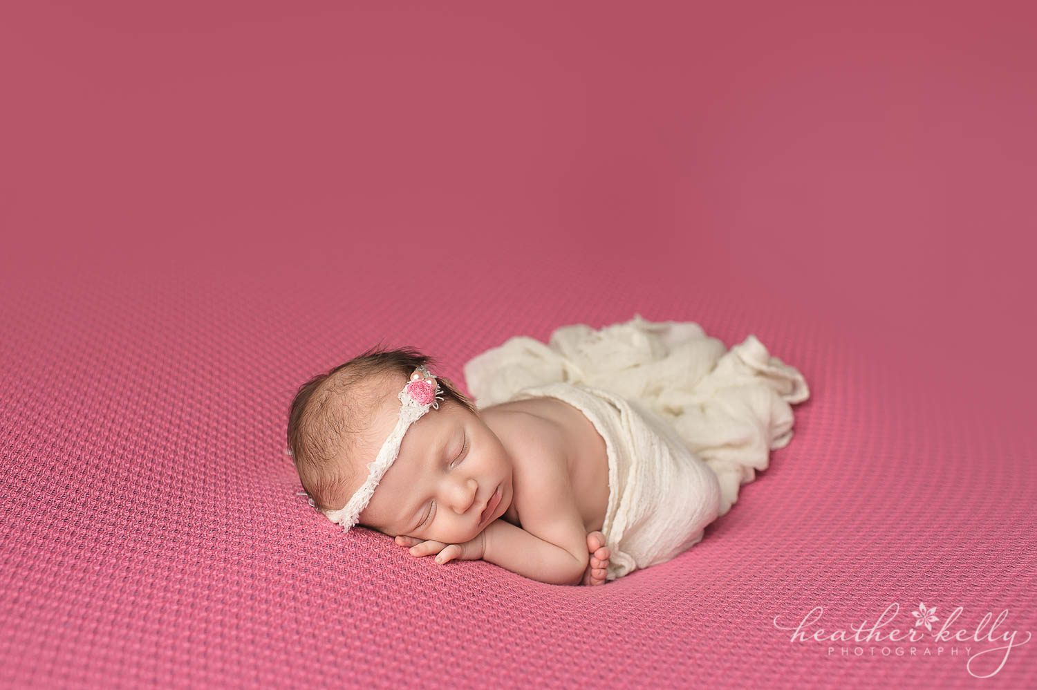 newborn girl in taco pose with wrap. newborn photography poses. 