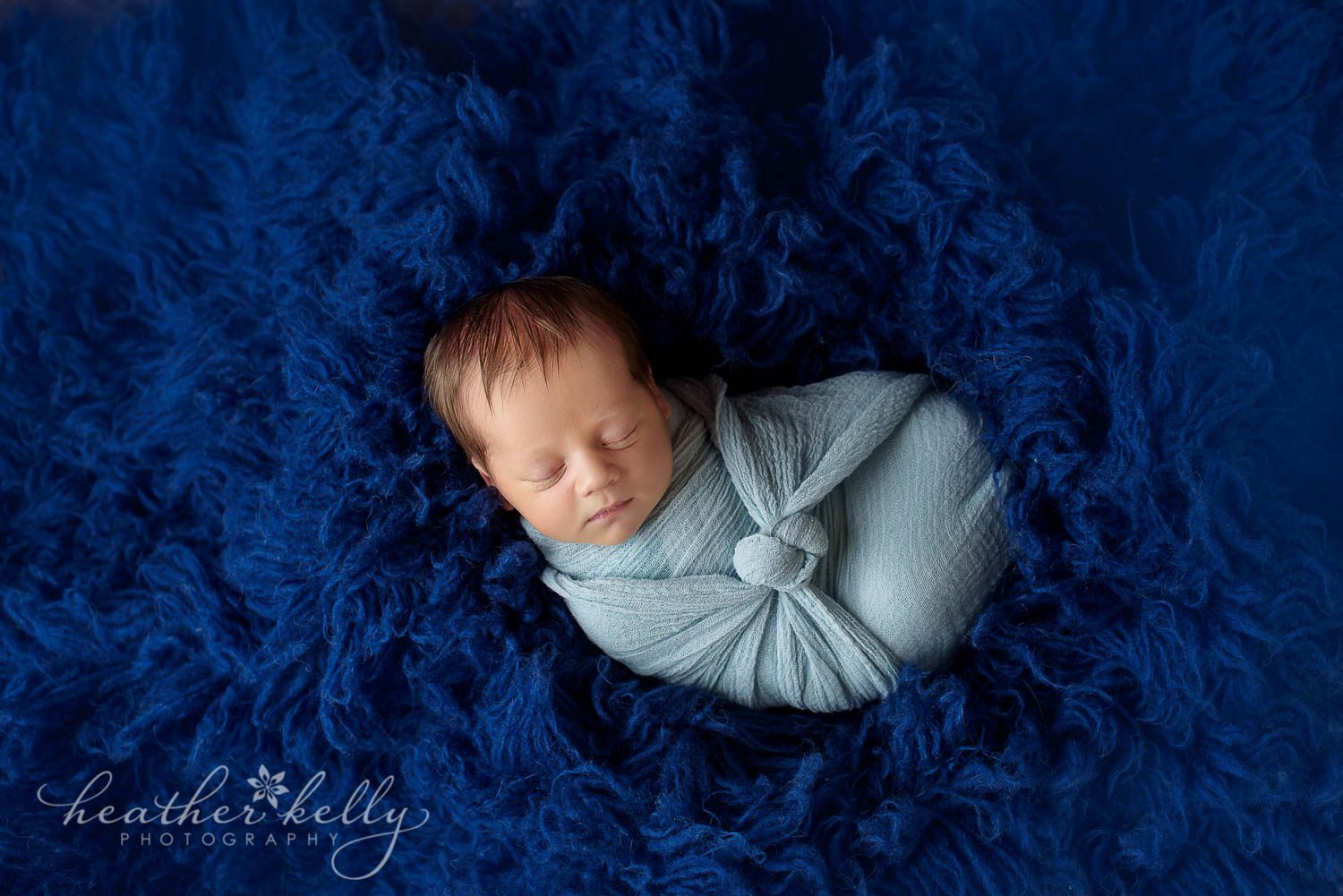 baby boy newborn photography wrapped on blue