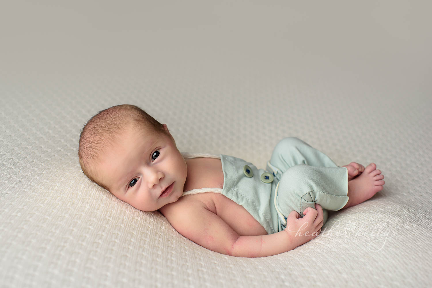 awake newborn boy in cute blue outfit for newborn photo shoot. shelton newborn photography