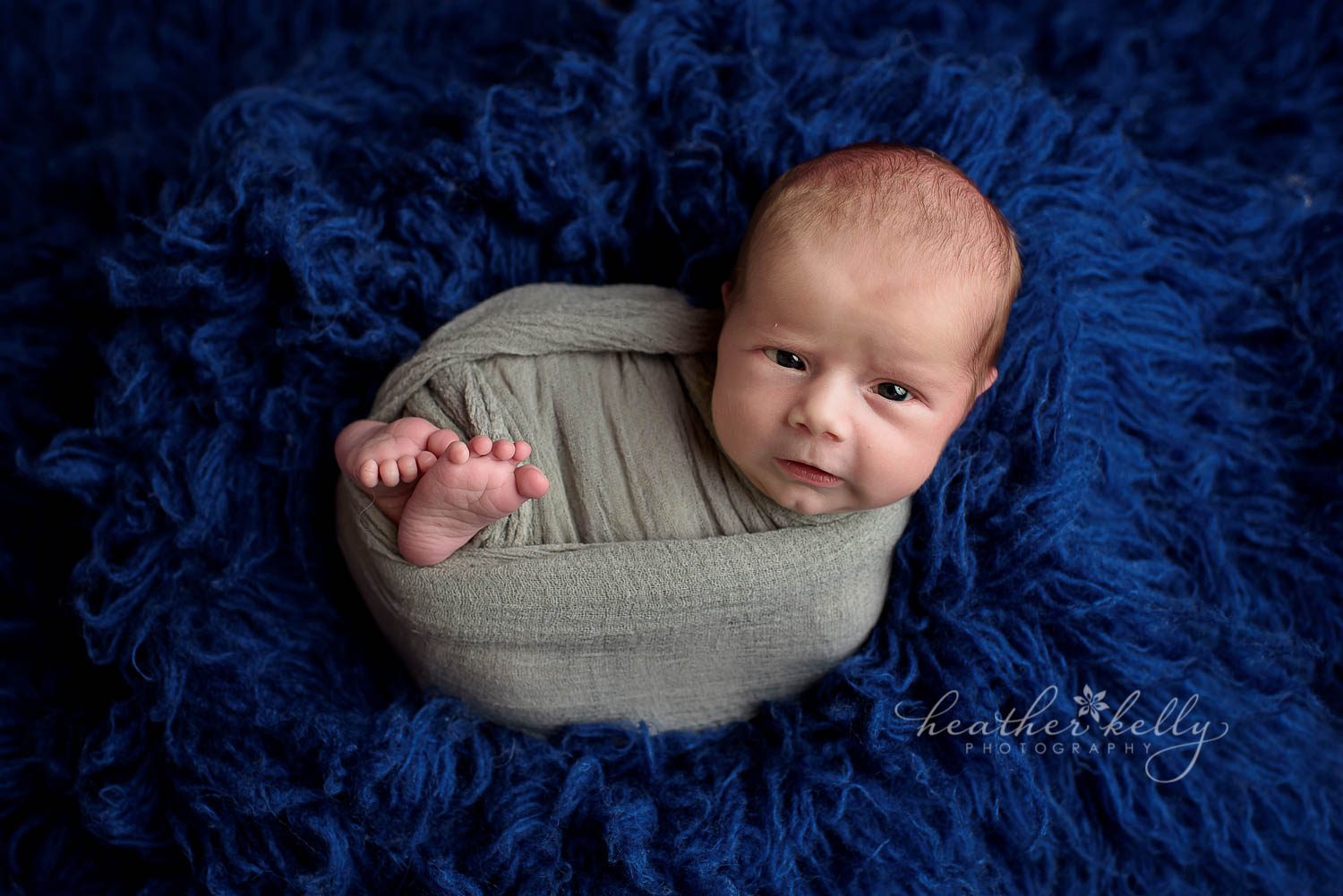 baby wrapped and awake with feet poking out. newborn photography shelton ct