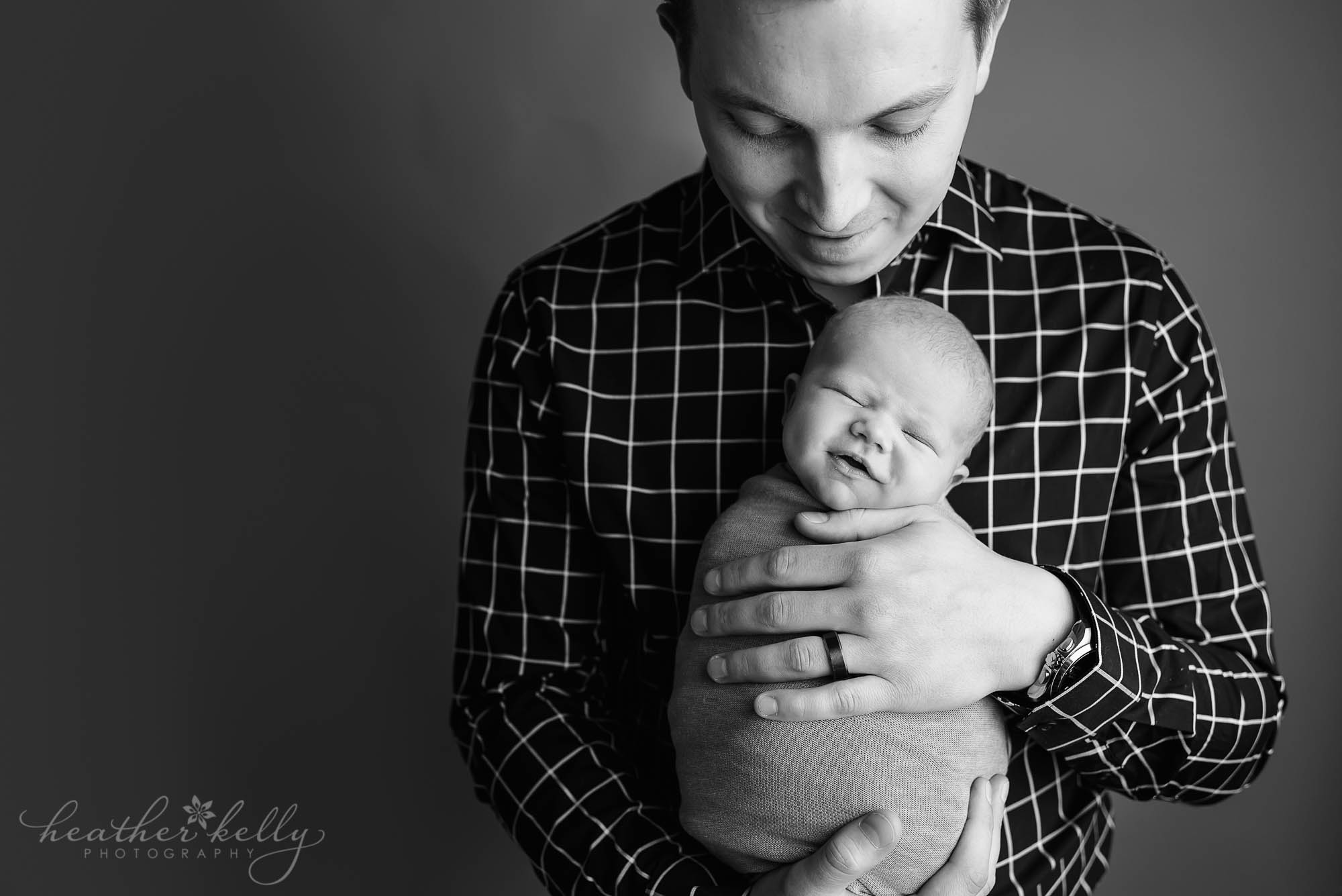 dad holding newborn son. dads with newborns. ct photographer