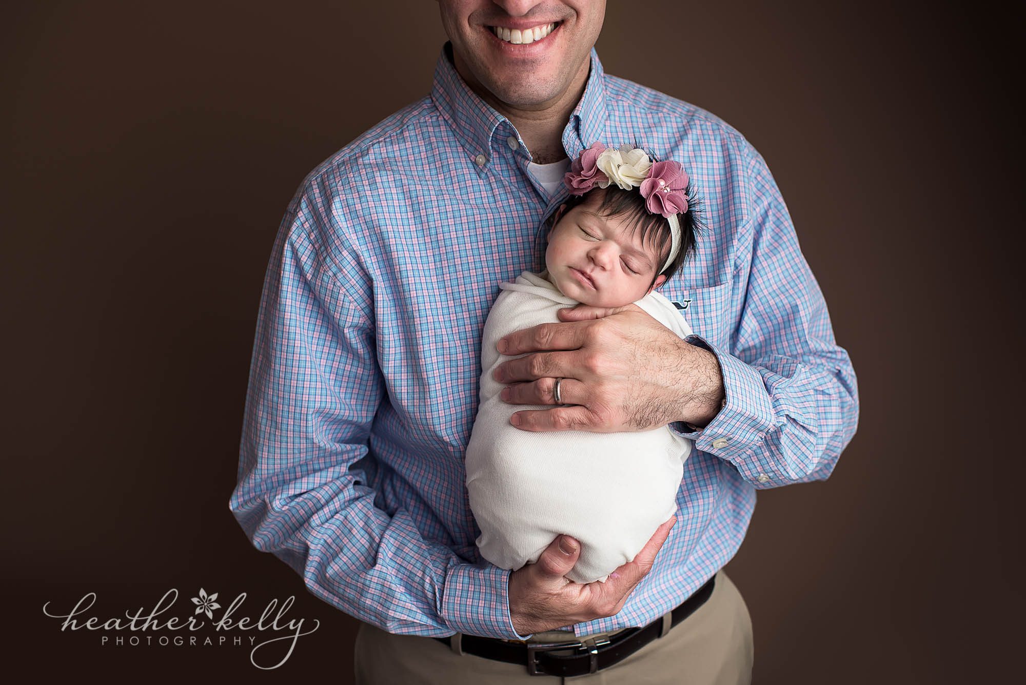 dad holding newborn daughter. milford ct newborn photography