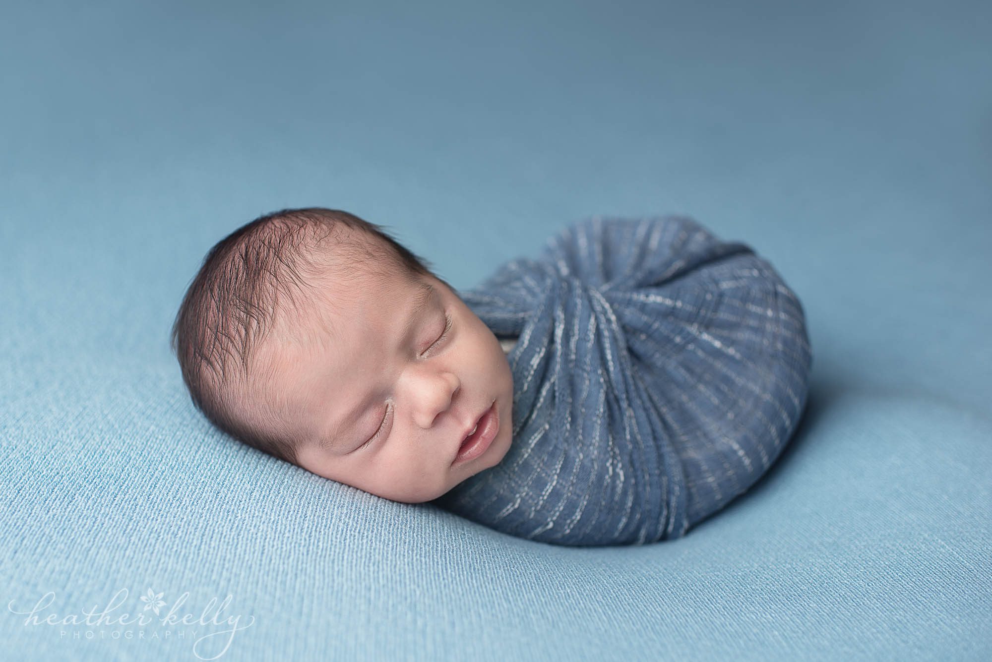 sweet baby boy wrapped in blue. newborn photography ct