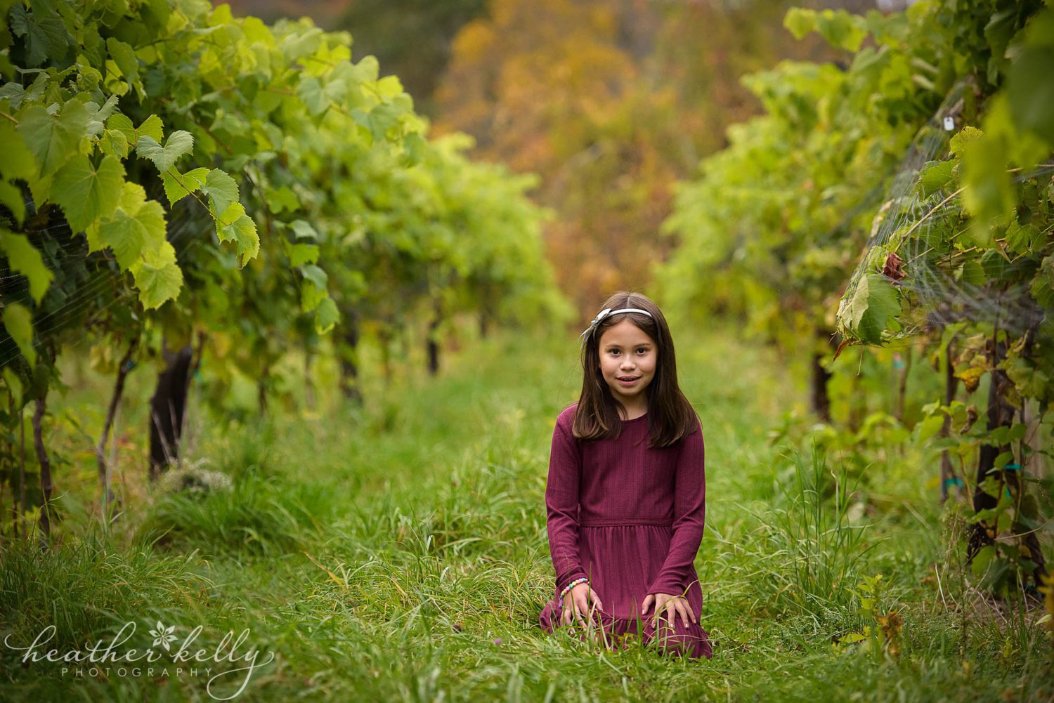 Girl posing in between vines during a CT photography session at Aquila's Nest Vineyard in Newtown CT 