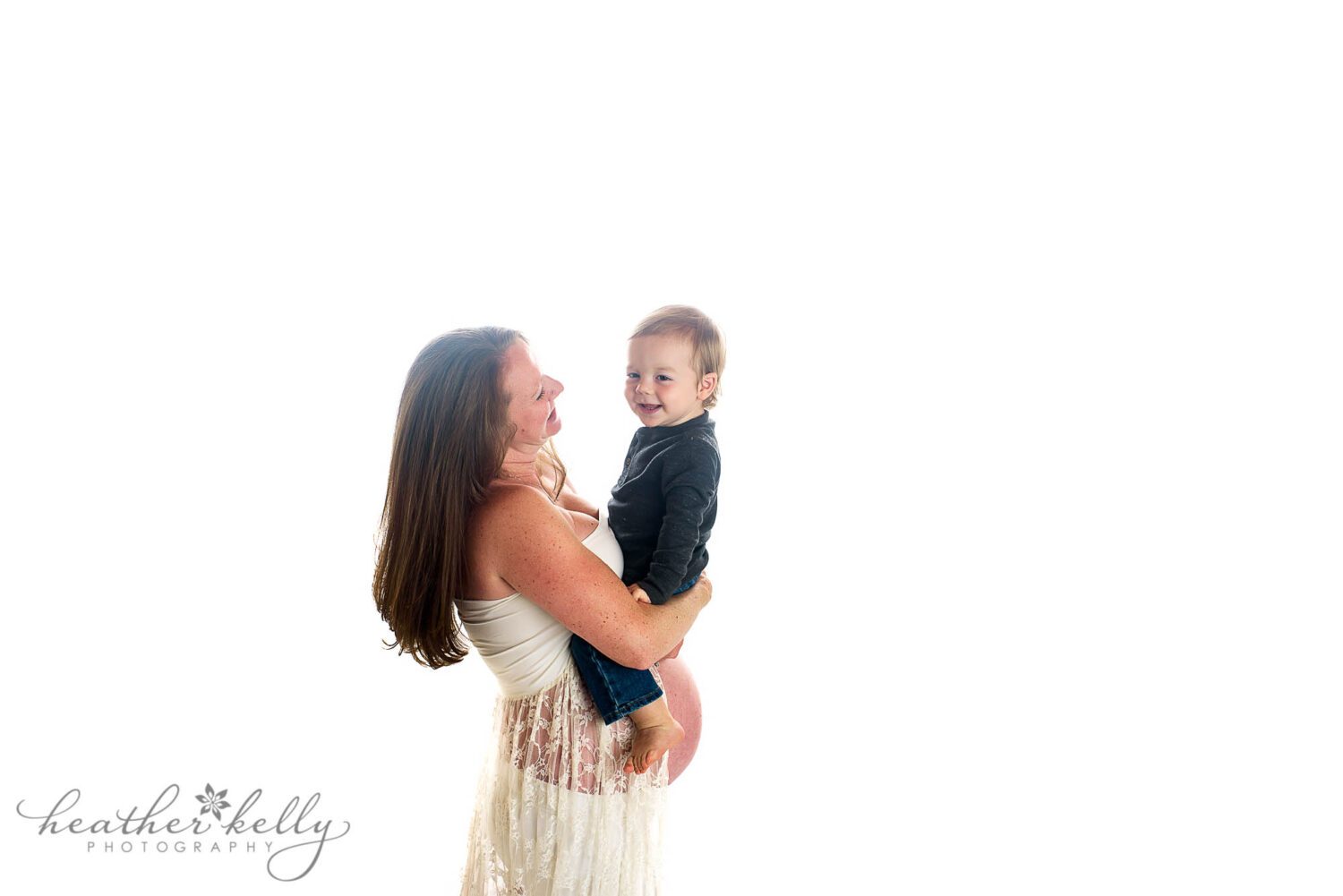 sandy hook maternity photography

35 week pregnant mom holding her 20 month old son above her belly. They are both laughing. 