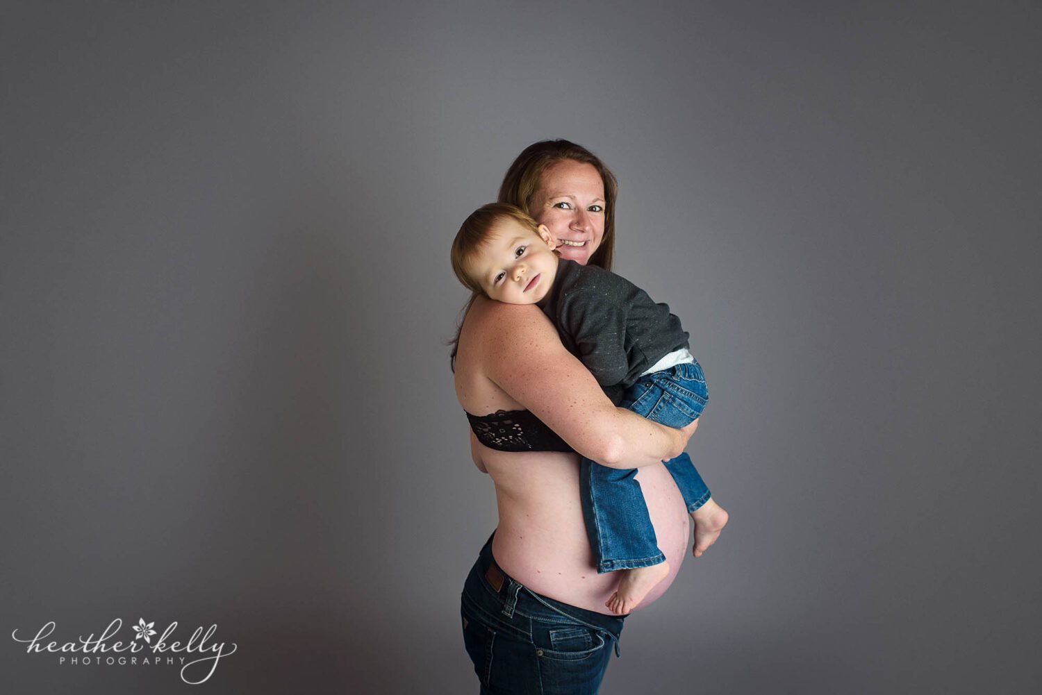 20 month old boy rests his head on his pregnant mom's shoulder. 

sandy hook maternity photography