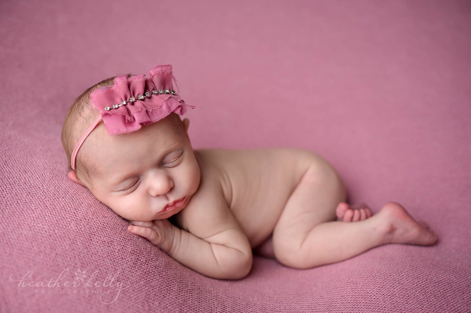 newborn photos of a sleeping newborn girl on pink. 