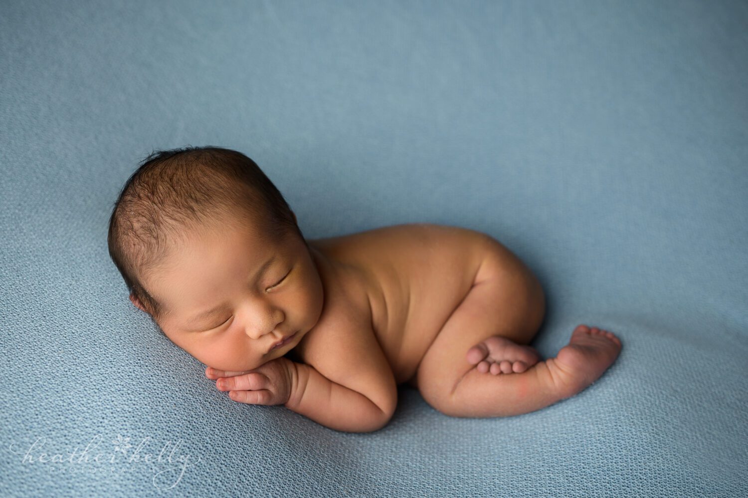 a ct newborn photographer posed a baby boy on a blue backdrop. newborn photography information