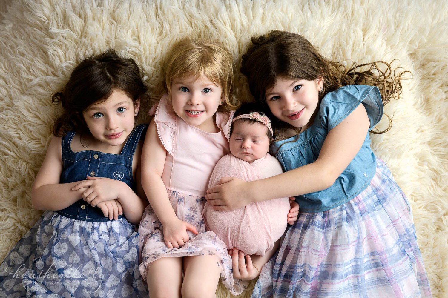 4 sisters cuddle together for the ct newborn photo session. 