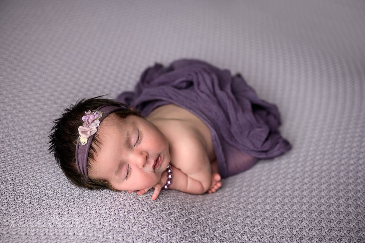 a sleeping newborn girl poses for her newtown ct newborn photo session